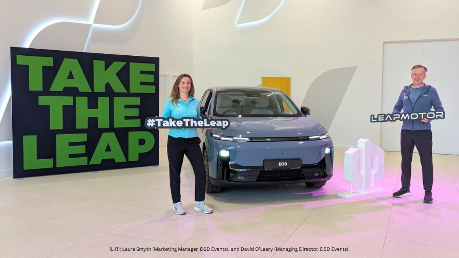 Two people stand beside a car, with the phrase "Take the Leap" prominently displayed in the background